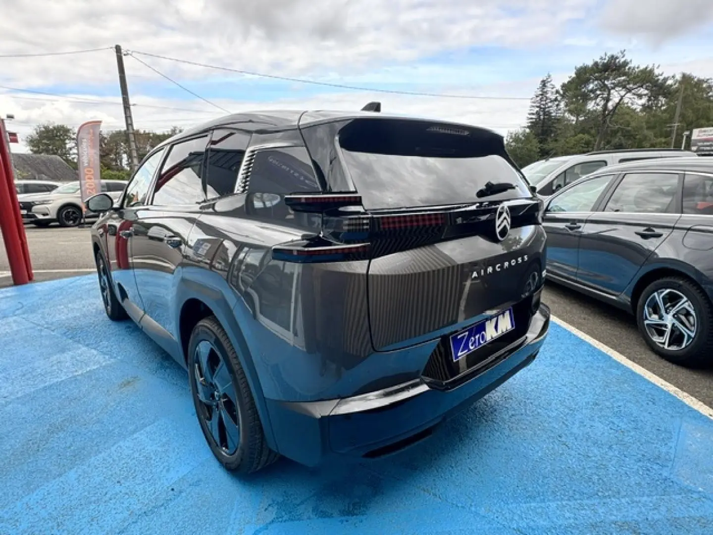 Vue 3/4 arrière droite du Citroën C5 Aircross gris Platinium avec feux arrière LED et jantes noires.