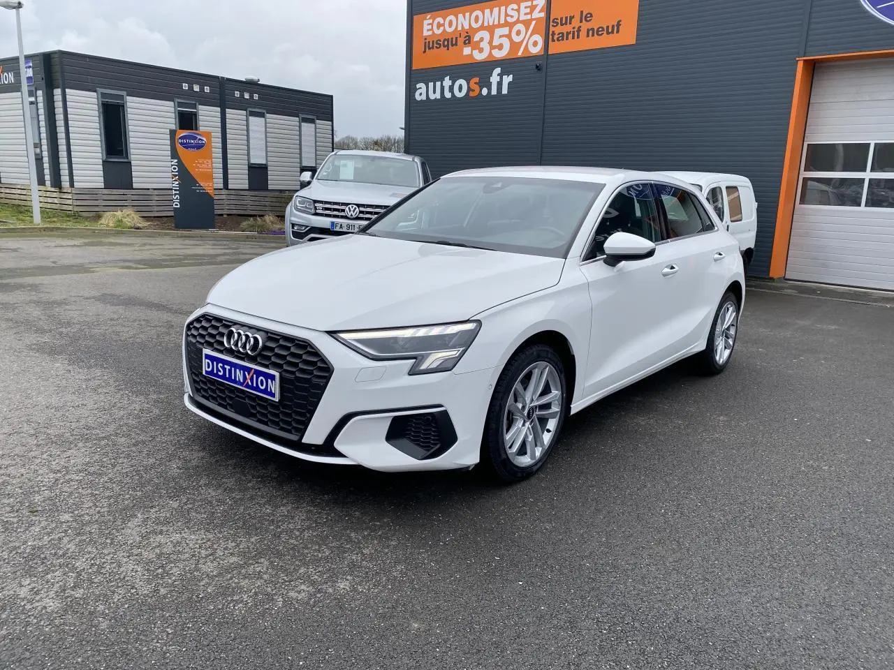 Audi A3 Sportback blanc Ibis vue 3/4 avant droit avec calandre hexagonale noire et phares LED distinctifs.