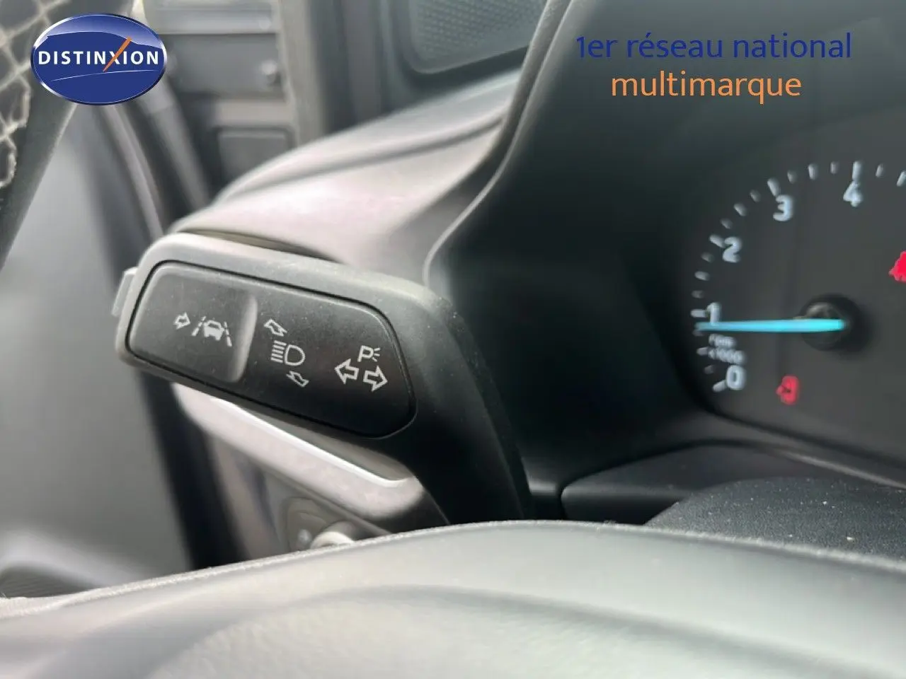 Détail du commodo gauche avec commandes d'éclairage et d'aide à la conduite dans le tableau de bord d'un Ford Puma gris 2021.