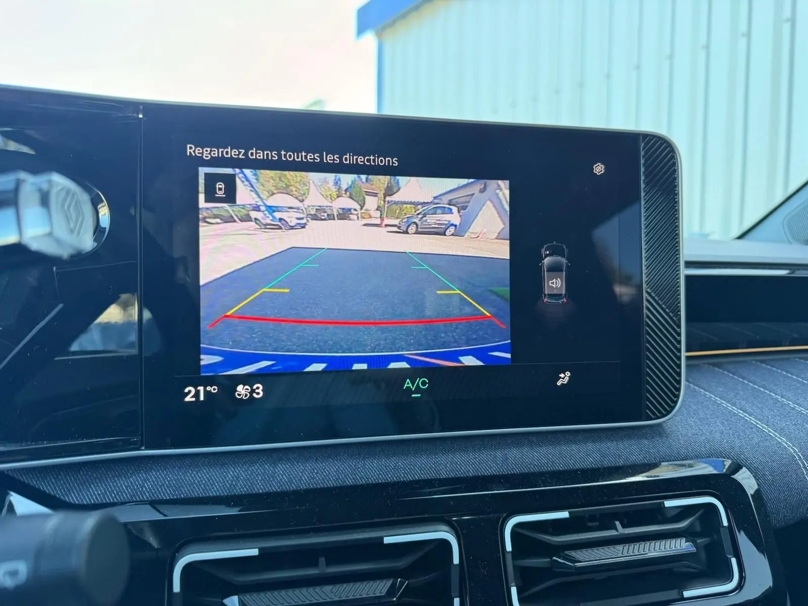 Écran multimédia de la Renault R5 E-TECH montrant la caméra de recul avec affichage des lignes de guidage colorées.