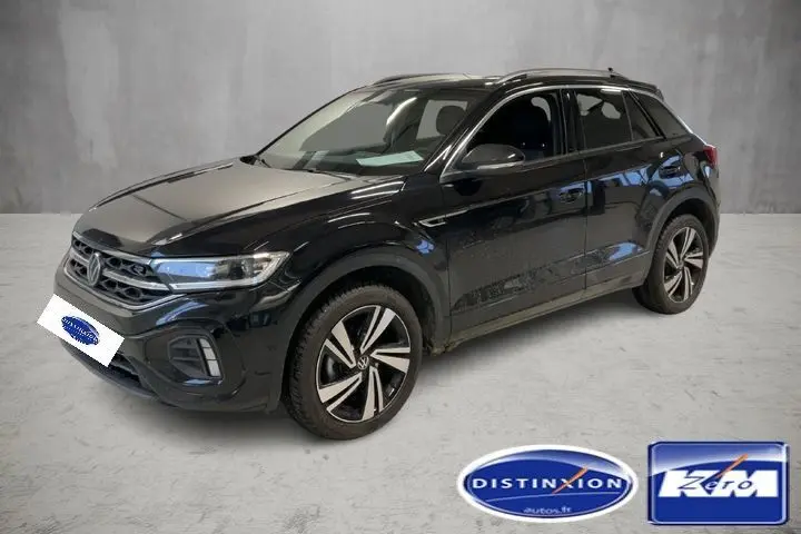 Volkswagen T-Roc noir intense en 3/4 avant droit, avec jantes bi-ton et calandre R-Line distinctive.