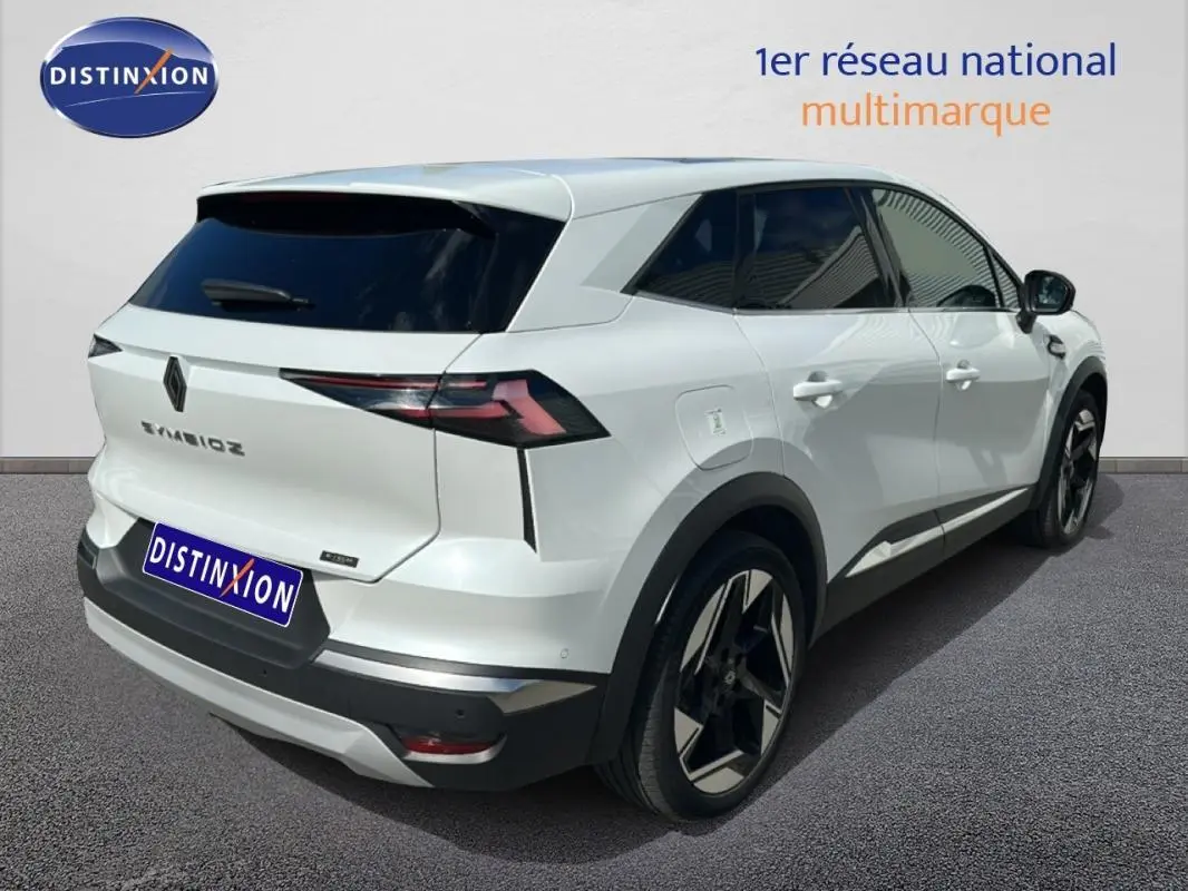 Vue 3/4 arrière droite d'une Renault SYMBIOZ E-Tech full hybrid blanche avec jantes alliage 19 pouces et vitres teintées.