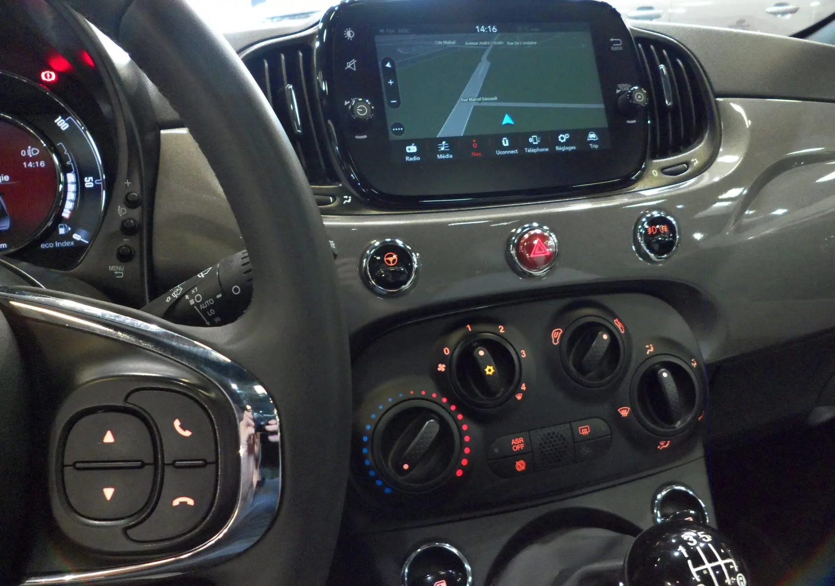 Intérieur de la Fiat 500 Electroclash Grey, vue du tableau de bord avec écran tactile et levier de vitesses manuel.