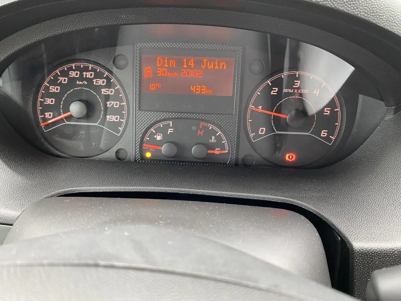 Vue rapprochée du tableau de bord noir de l'Opel Movano Fourgon blanc, affichant vitesse, compte-tours et informations numériques.