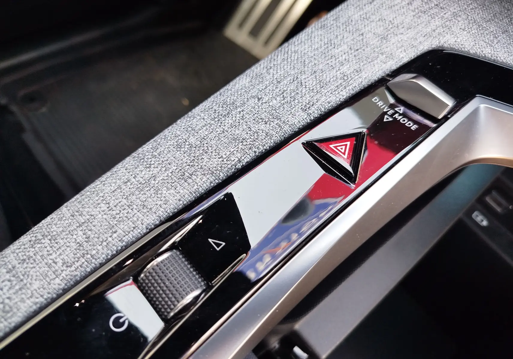 Gros plan sur la console centrale du Peugeot 3008 2024, avec bouton d’alerte triangulaire rouge et molette de réglage.