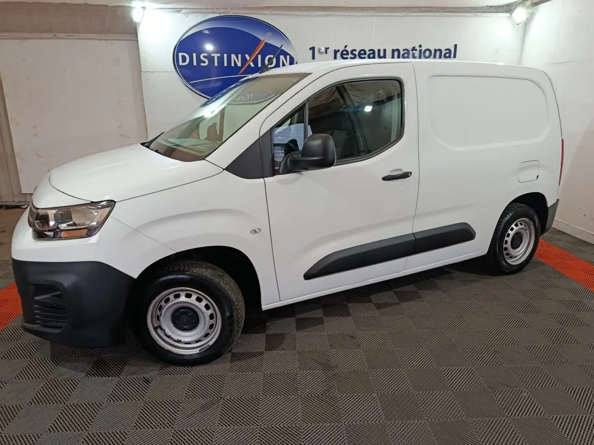 Vue de profil côté gauche d’un utilitaire Citroën Berlingo blanc avec jantes acier et pare-chocs noirs.