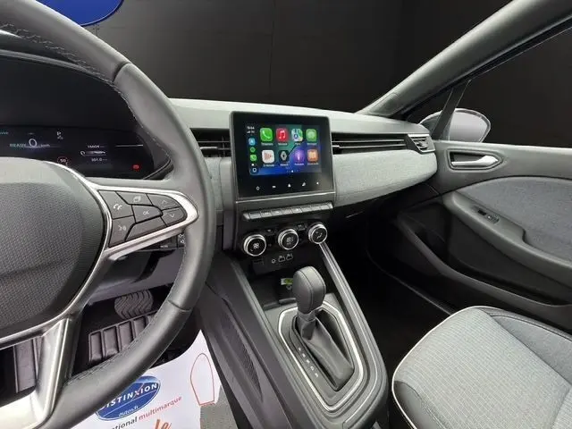 Vue intérieure côté conducteur de la Renault Clio Techno E-Tech 2025, avec écran tactile central et volant multifonctions.