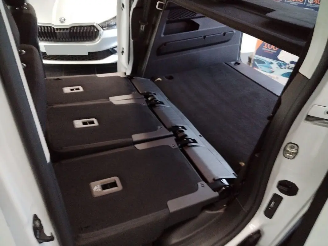 Vue 3/4 arrière droite du Citroën Berlingo gris Artense avec feux arrière rouges et jantes noires.