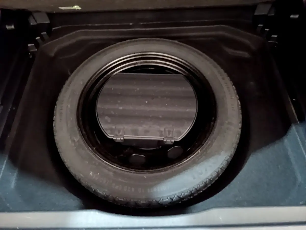 Vue rapprochée de la roue de secours noire dans le coffre du Citroën C5 Aircross gris foncé 2020.