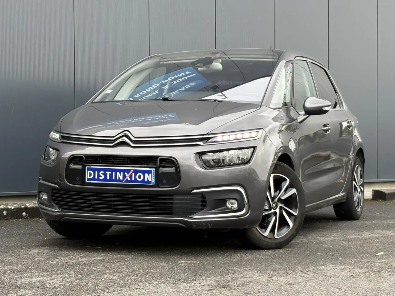 Citroën C4 Spacetourer gris foncé en 3/4 avant droit avec jantes alliage et feux LED allumés.