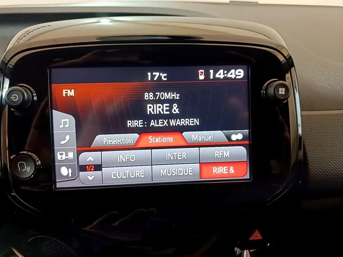 Écran tactile central de la Citroën C1 gris clair, affichant la radio FM avec station "RIRE &" en mode 14h49.
