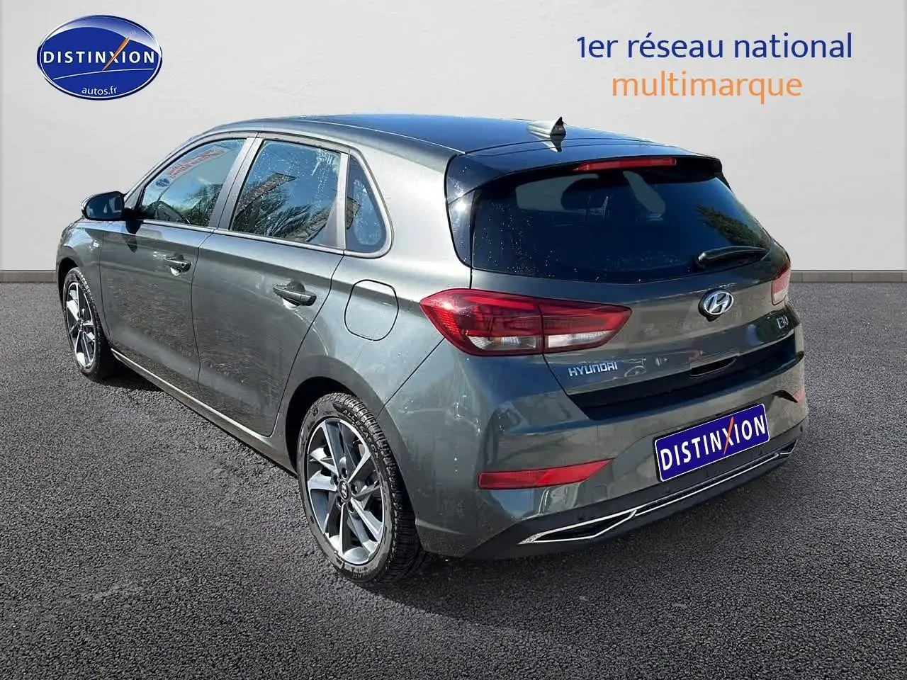 Vue 3/4 arrière droite d'une Hyundai i30 gris argent 2024 avec jantes alu et vitres arrière surteintées.