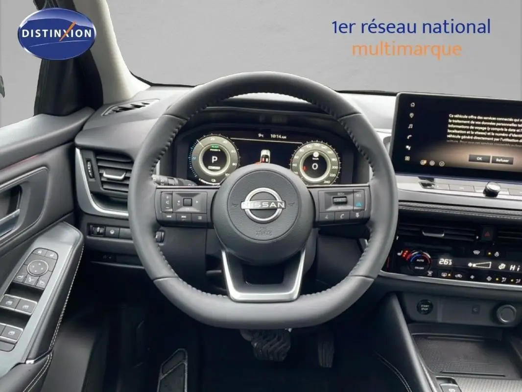 Vue intérieure centrée sur le volant cuir Nissan Qashqai noir avec cockpit numérique et écran tactile.
