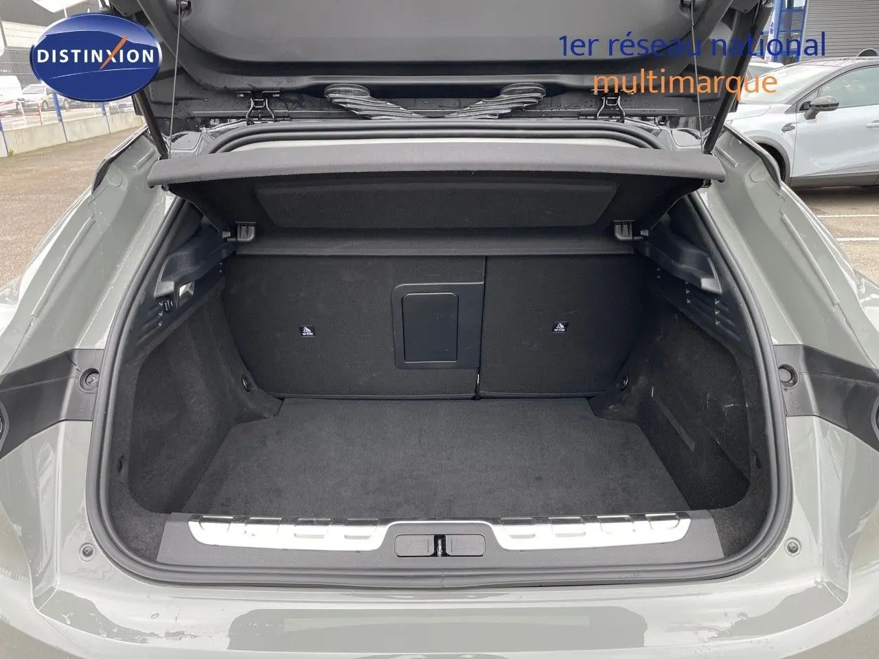 Coffre ouvert d'une DS4 2024 gris laqué métal, vue arrière montrant l'espace de chargement et la tablette cache-bagages.