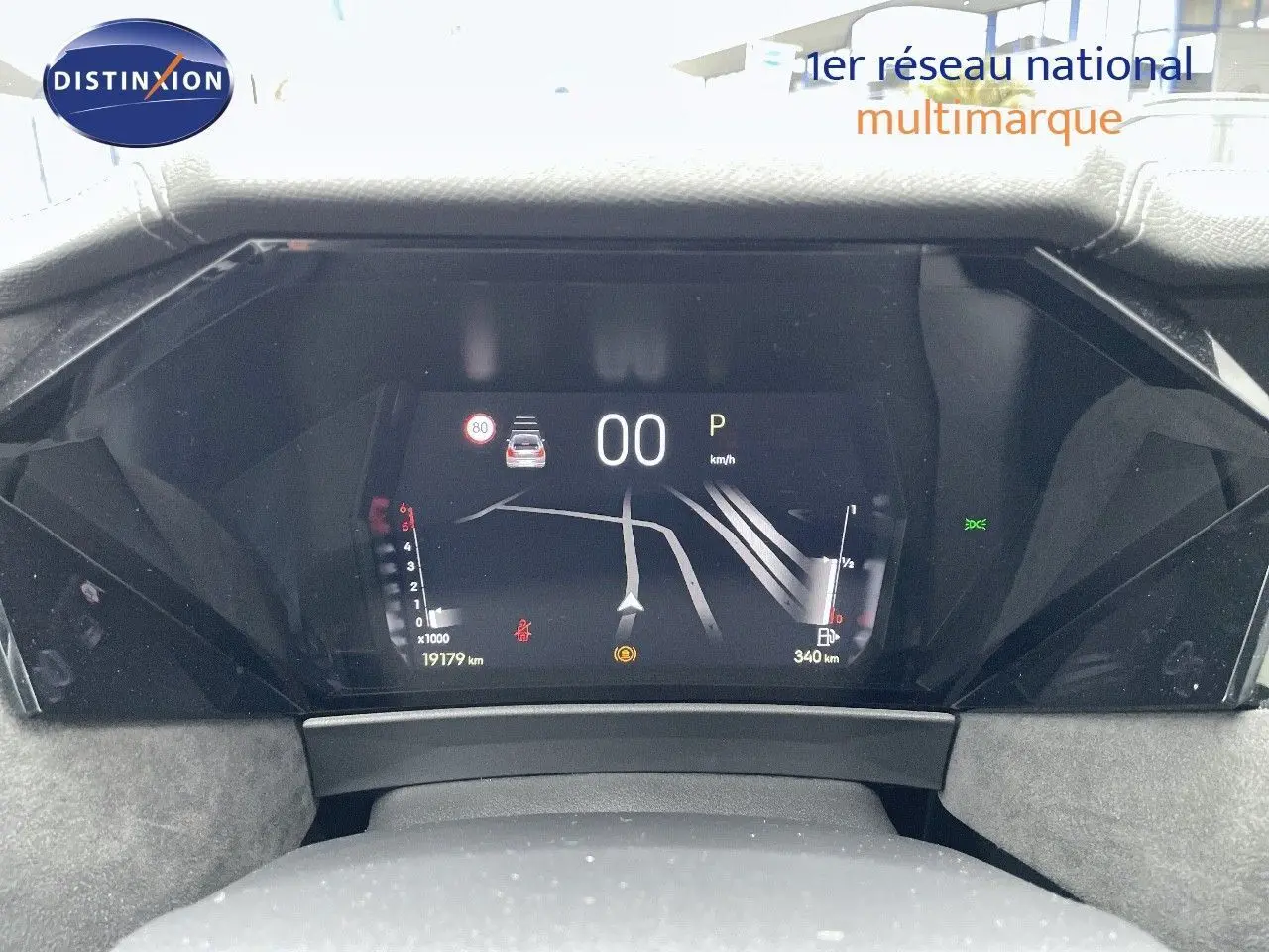 Vue rapprochée du tableau de bord numérique du DS4 gris laqué métal, affichant la navigation et les indicateurs de vitesse et carburant.