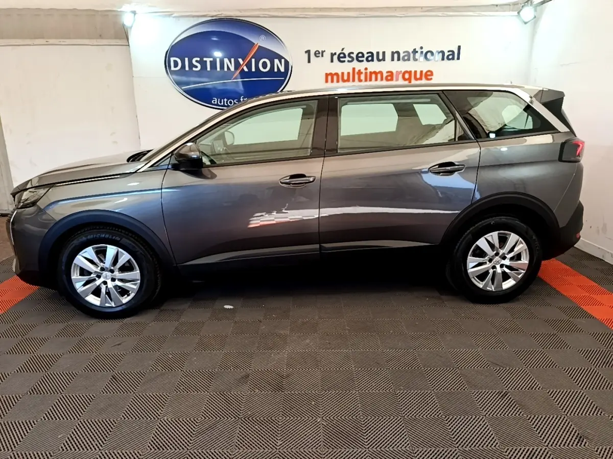 Profil côté gauche d’un Peugeot 5008 gris clair de 2021, avec jantes alliage et rétroviseurs électriques rabattables.