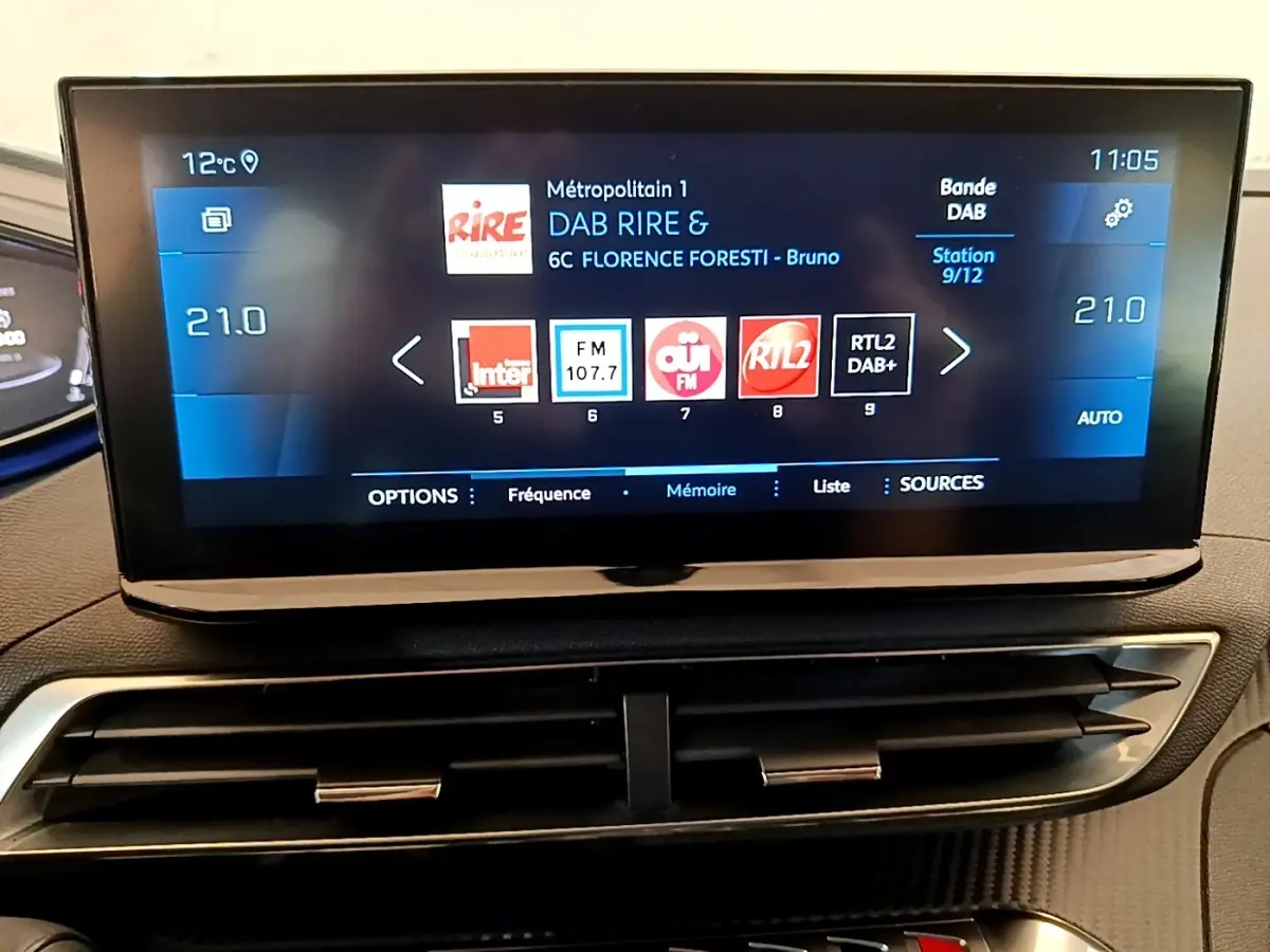 Écran tactile central affichant la radio DAB dans l’habitacle du Peugeot 5008 gris clair, vue rapprochée du tableau de bord.