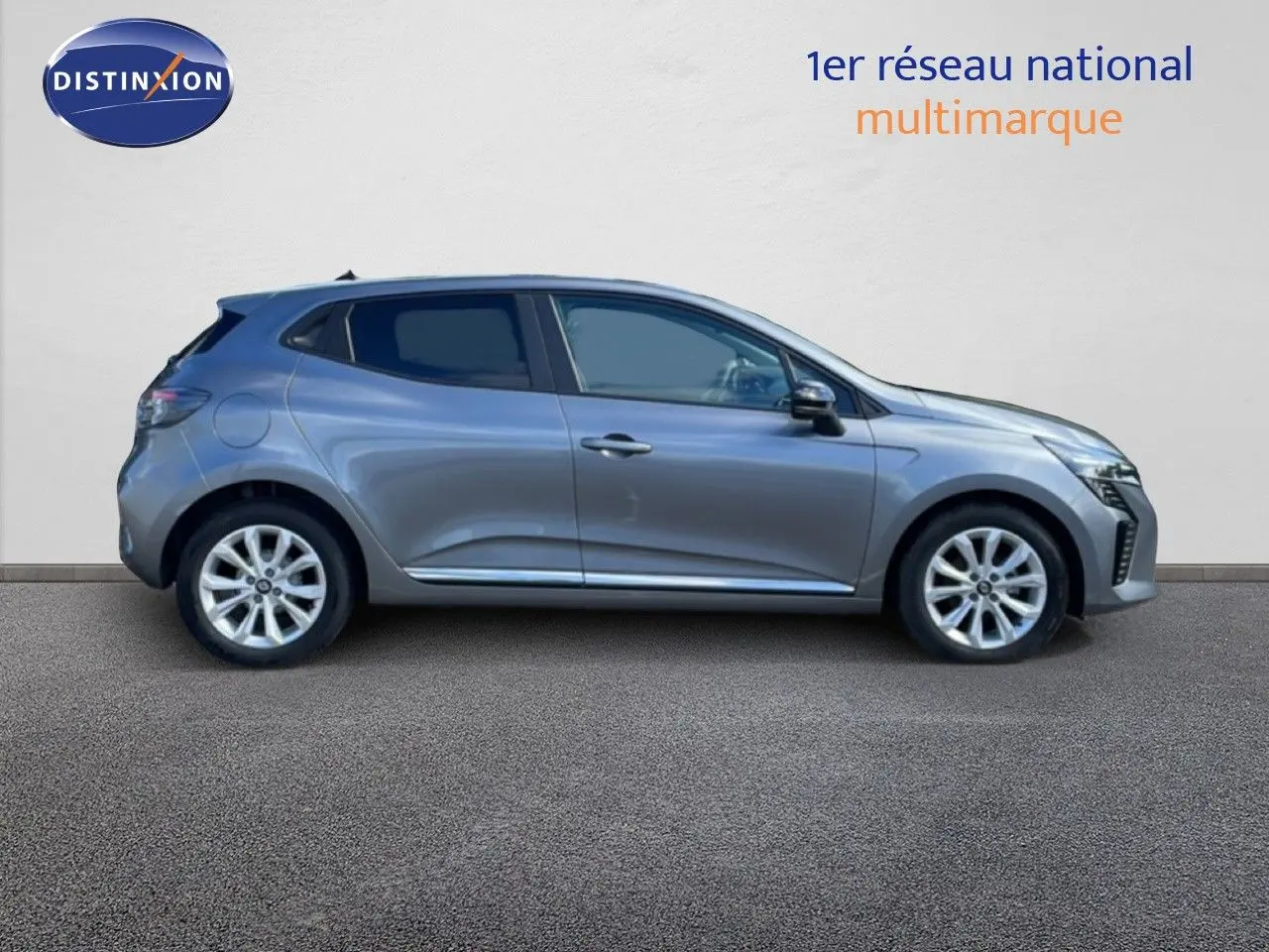 Profil droit d'une Renault Clio 2025 gris schiste métal, compacte et moderne, sur fond neutre avec logo Distinxion.