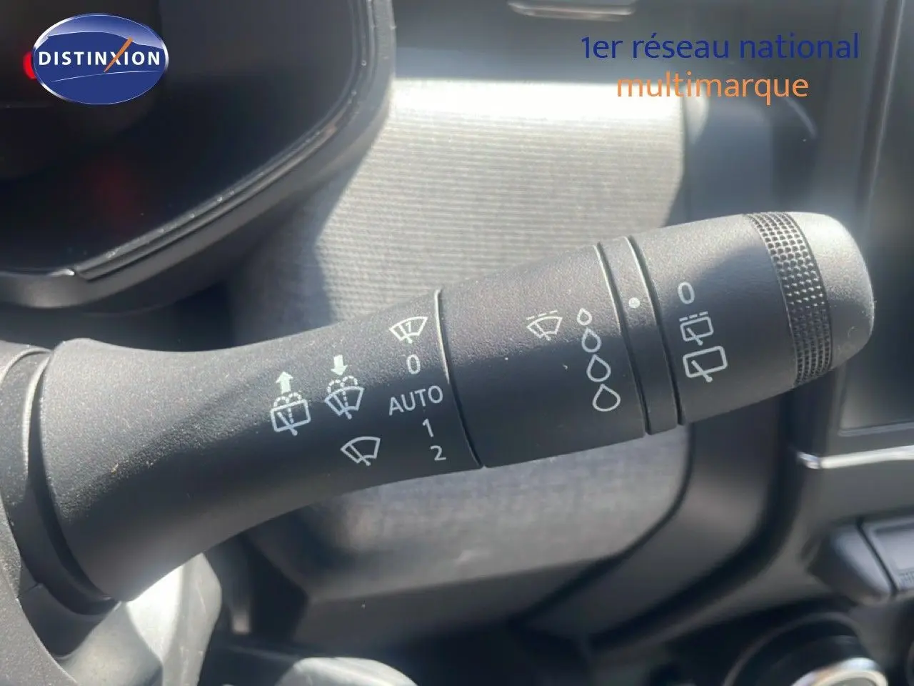 Gros plan sur la commande d’essuie-glace côté droit dans l’habitacle d’une Renault Clio blanche 2025.