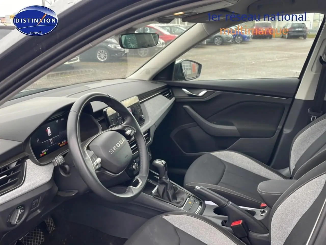 Vue intérieure côté conducteur du Skoda Kamiq gris 2025, volant cuir multifonction et tableau de bord digital.