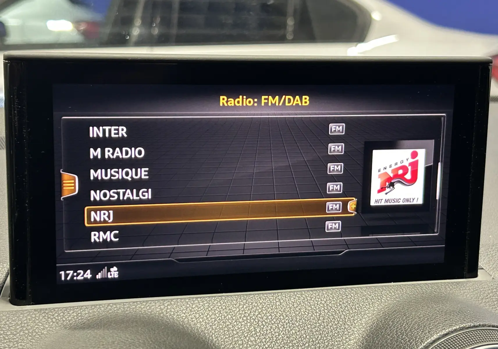 Écran central de l'Audi Q2 noir métal 2023 affichant les réglages audio du système de divertissement.