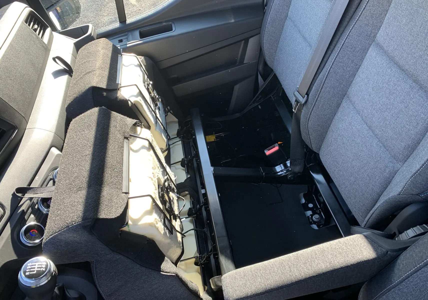 Vue intérieure du siège passager relevé du Renault Master 2025, tissu gris et console centrale avec levier de vitesses manuel visible.