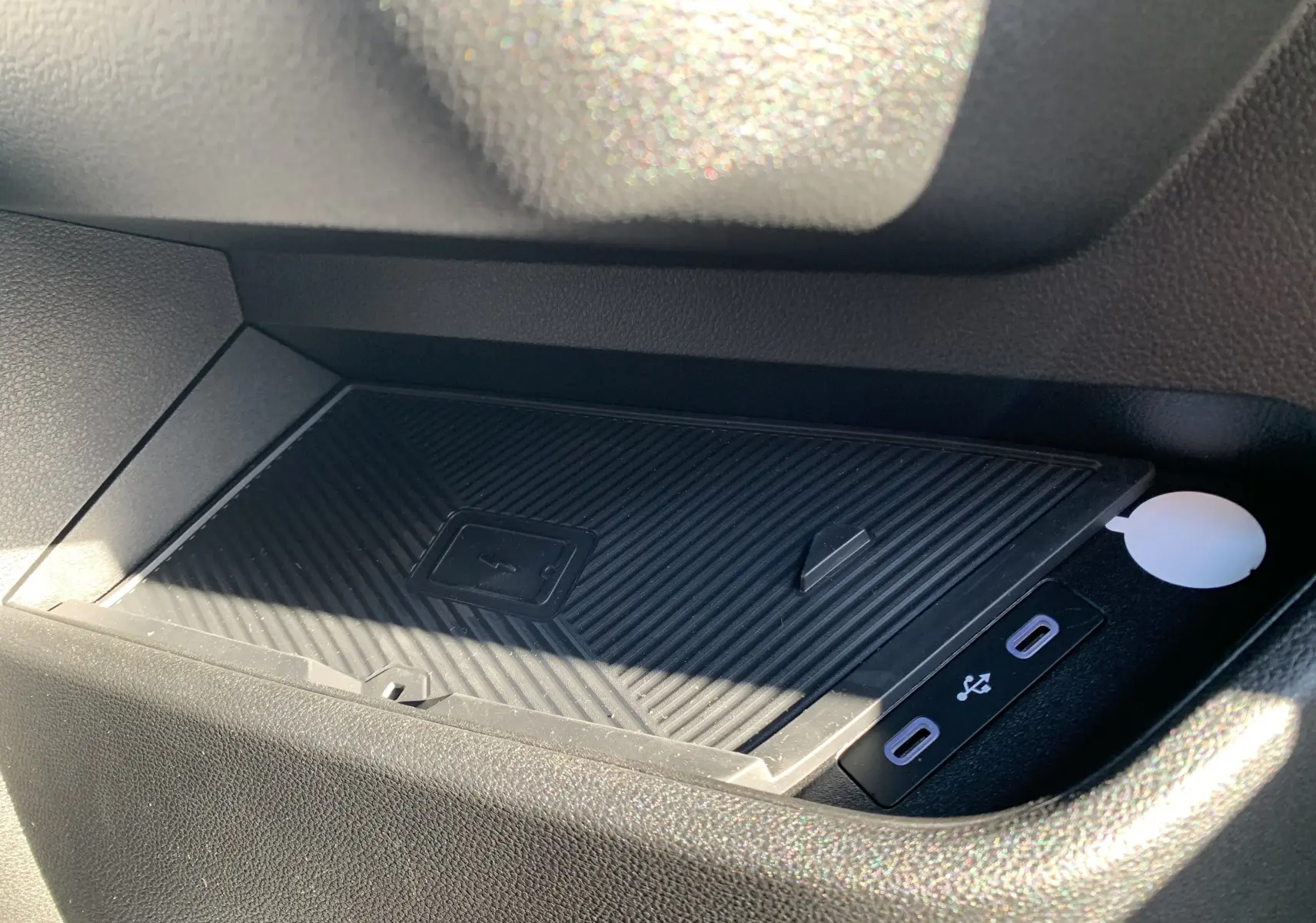 Plateau de recharge sans fil et double port USB-C dans l'habitacle du Renault Master blanc, vue rapprochée côté passager.