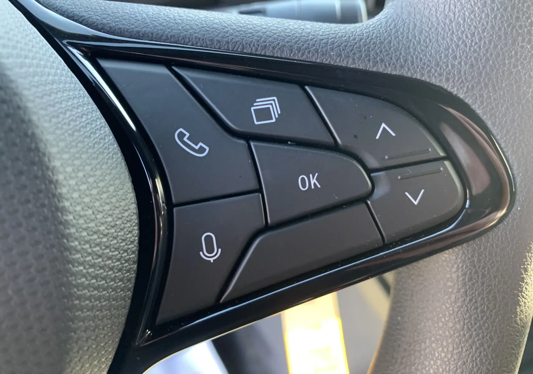 Gros plan sur les commandes noires du volant du Renault Master 2025, boutons multifonctions avec icônes blanches.