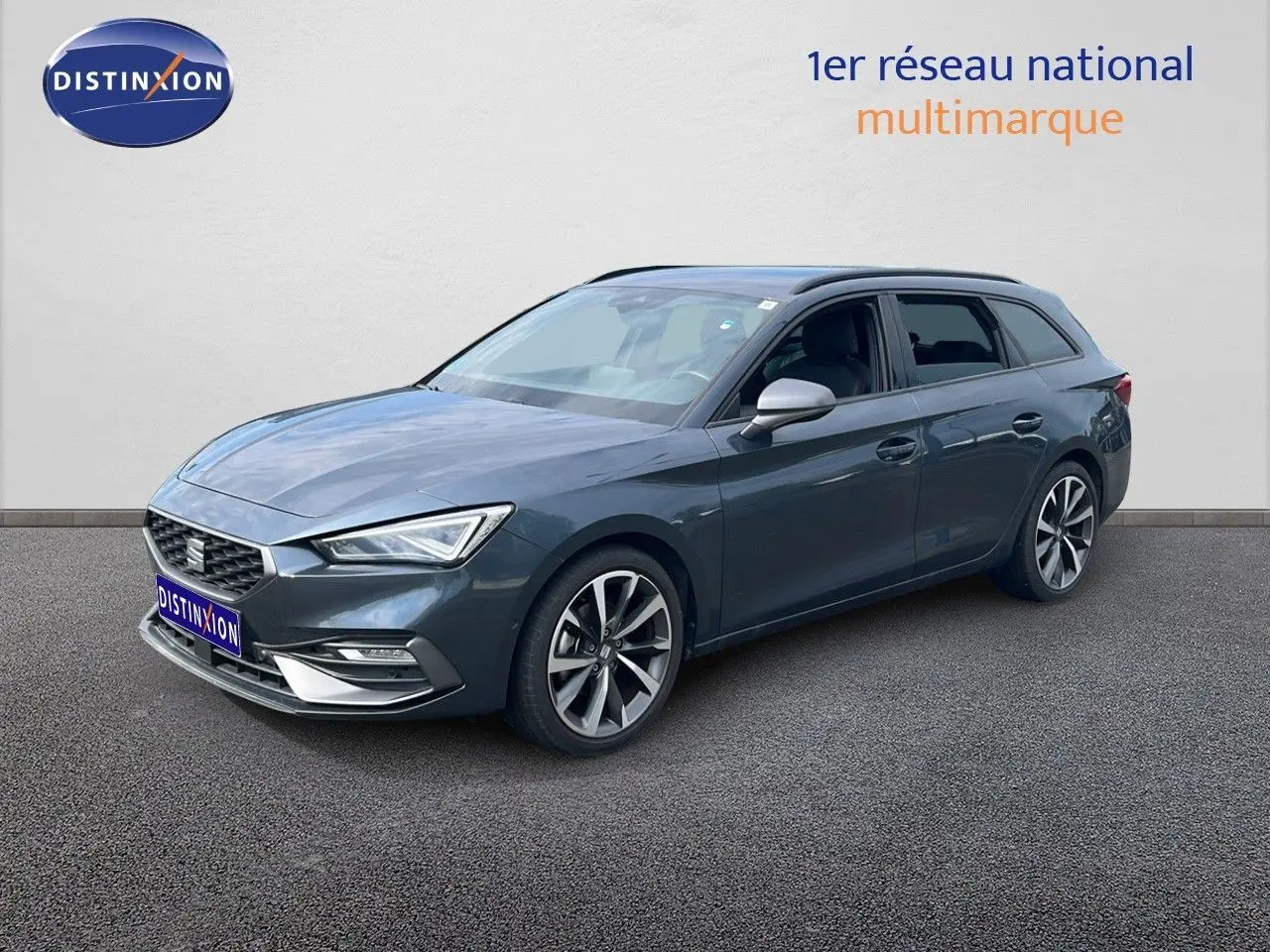 SEAT Leon ST 1.5 TSI gris magnétique métal en 3/4 avant droit, avec jantes alliage et lignes dynamiques.
