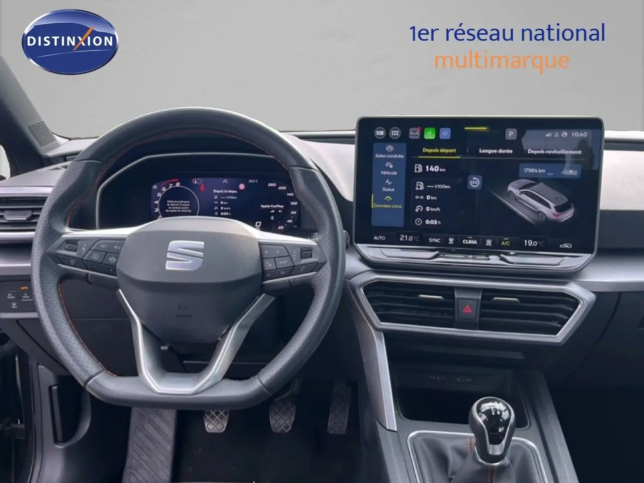Vue intérieure centrée sur le volant et le tableau de bord numérique d'une SEAT LEON ST gris magnétique 2025 avec boîte manuelle.