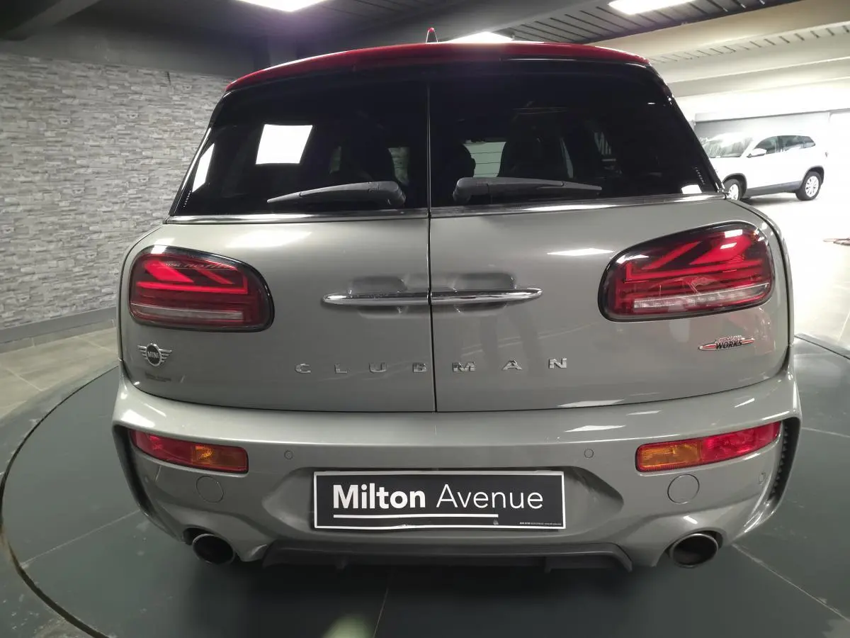 Vue arrière d'une MINI Clubman John Cooper Works gris métallisé avec double sortie d'échappement et feux LED distinctifs.