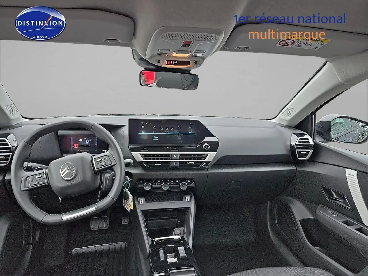 Intérieur de la Citroën C4 1.2 hybride 136 plus 2025, vue frontale du tableau de bord et volant cuir noir.