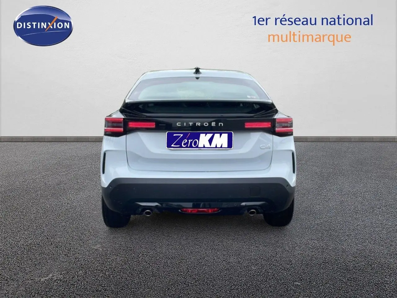 Vue arrière d'une Citroën C4 blanc métal avec toit noir, feux LED et double sortie d'échappement visible.