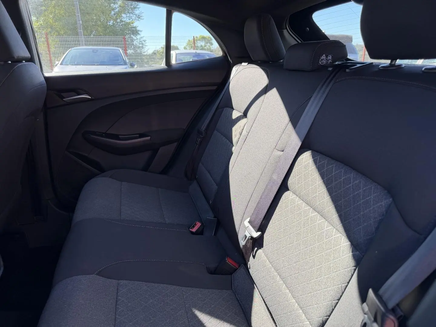 Vue intérieure côté droit de la banquette arrière en tissu noir du MG3 1.5 Hybrid+ 2024 Pebble Black métallisé.