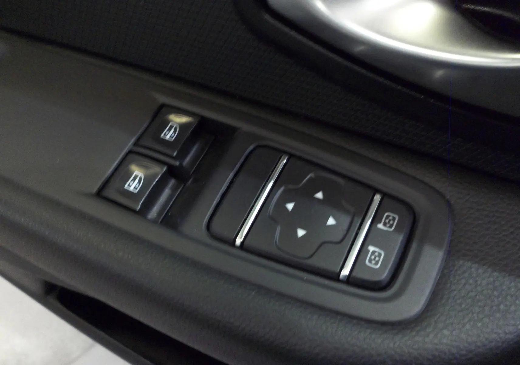 Commandes électriques des vitres et réglage des rétroviseurs sur la porte côté conducteur d'une Renault Clio IV Societe blanche.