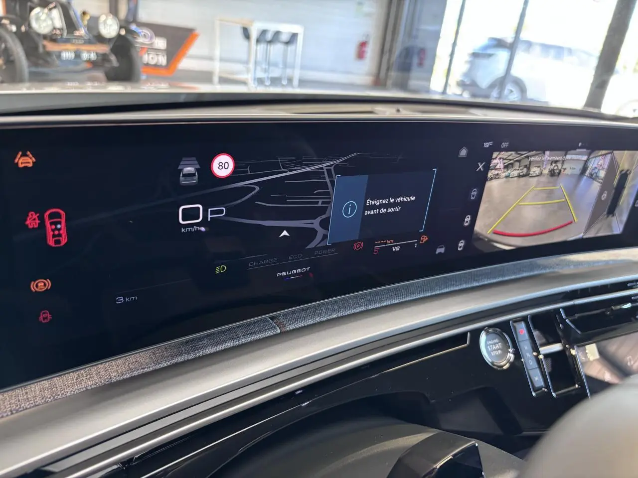 Vue intérieure du tableau de bord numérique et écran de caméra de recul du Peugeot 3008 hybride blanc.