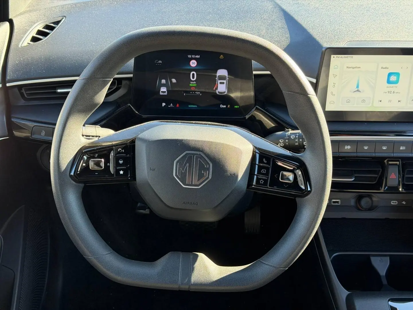 Vue rapprochée du volant multifonction gris foncé de la MG3 1.5 Hybrid+ 2024 avec tableau de bord numérique et écran tactile.