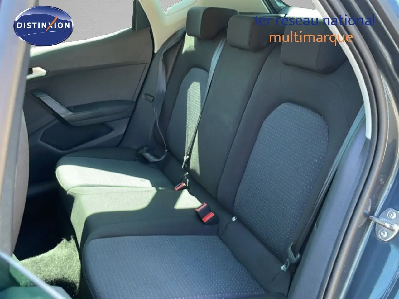 Vue intérieure arrière côté droit montrant les sièges arrière en tissu gris foncé avec motifs discrets sur un SEAT Arona 2025.