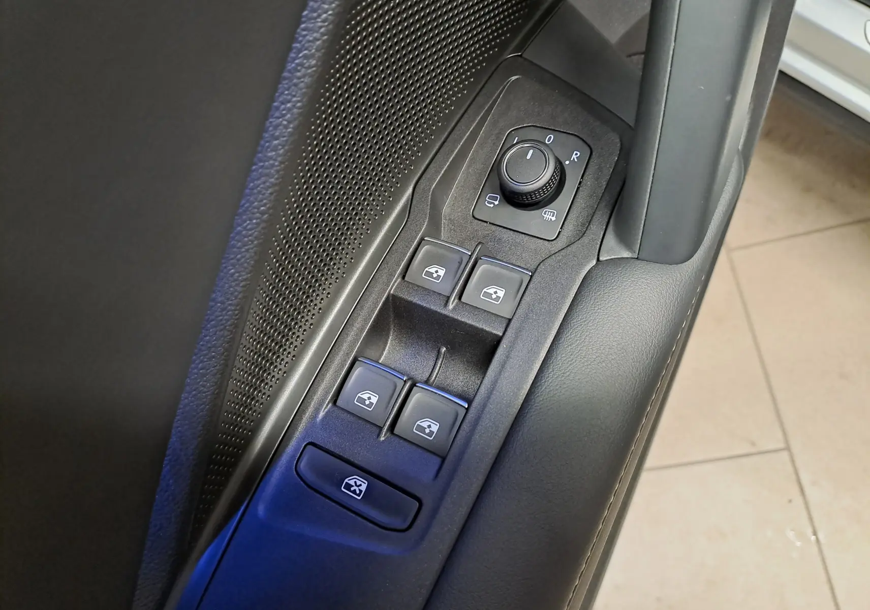 Gros plan sur les commandes des vitres et rétroviseurs côté gauche du Volkswagen Tiguan 2.0 TDI 150 DSG7 R-LINE.