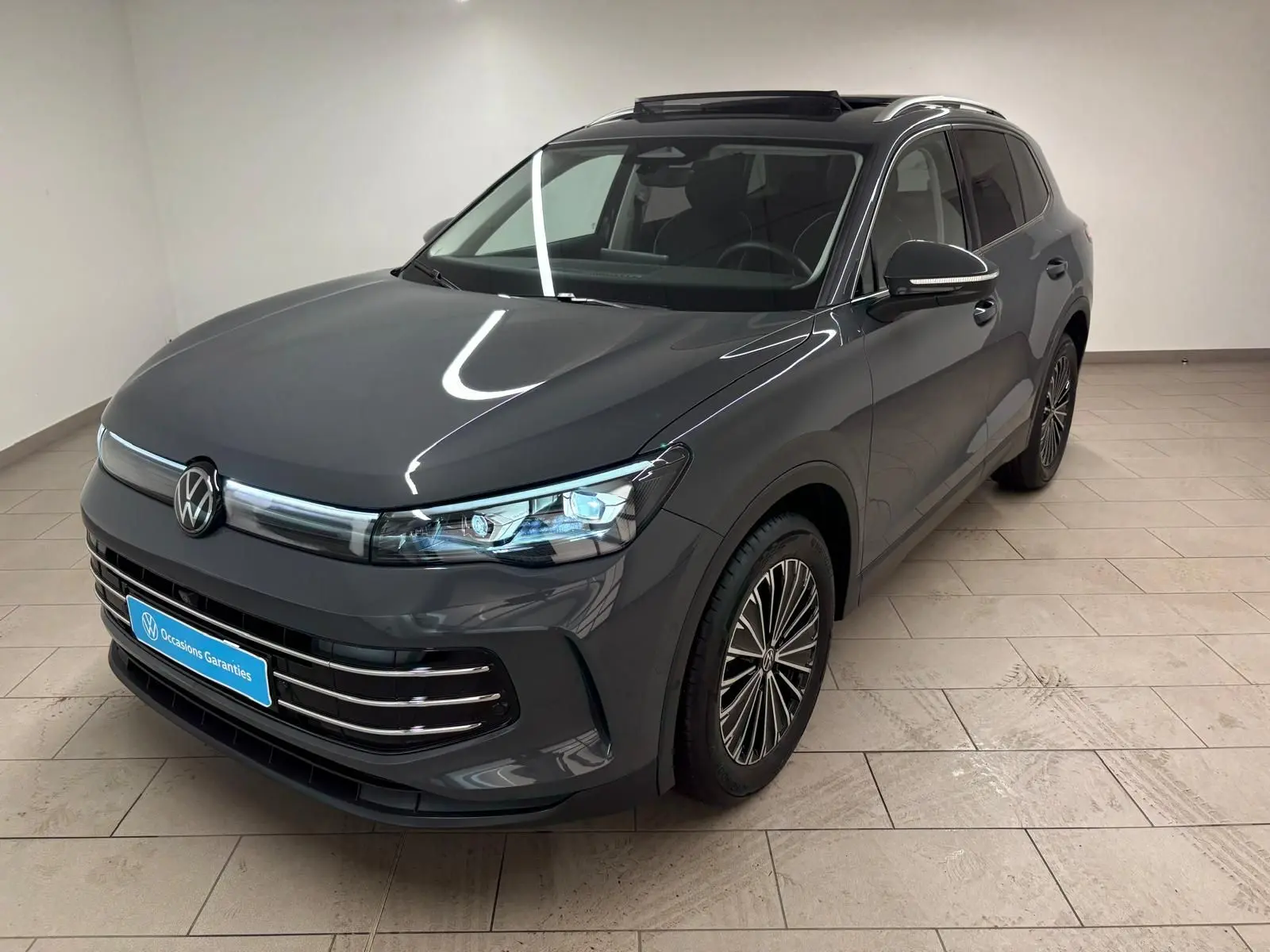 Volkswagen Tiguan 2.0 TDI 150 DSG7 Elegance gris dauphin, vue 3/4 avant droit en intérieur showroom.