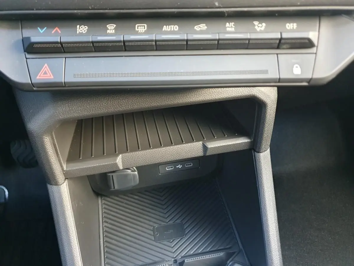 Vue rapprochée de la console centrale du Dacia Duster 2026, montrant les commandes climatisation et deux prises USB type C.