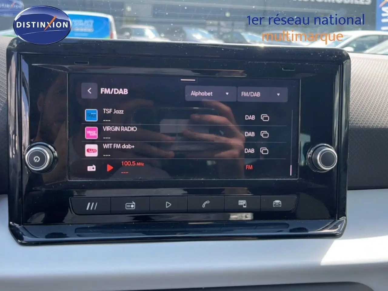 Écran tactile central du SEAT Arona 2025 affichant les stations radio FM/DAB, avec tableau de bord gris et noir.