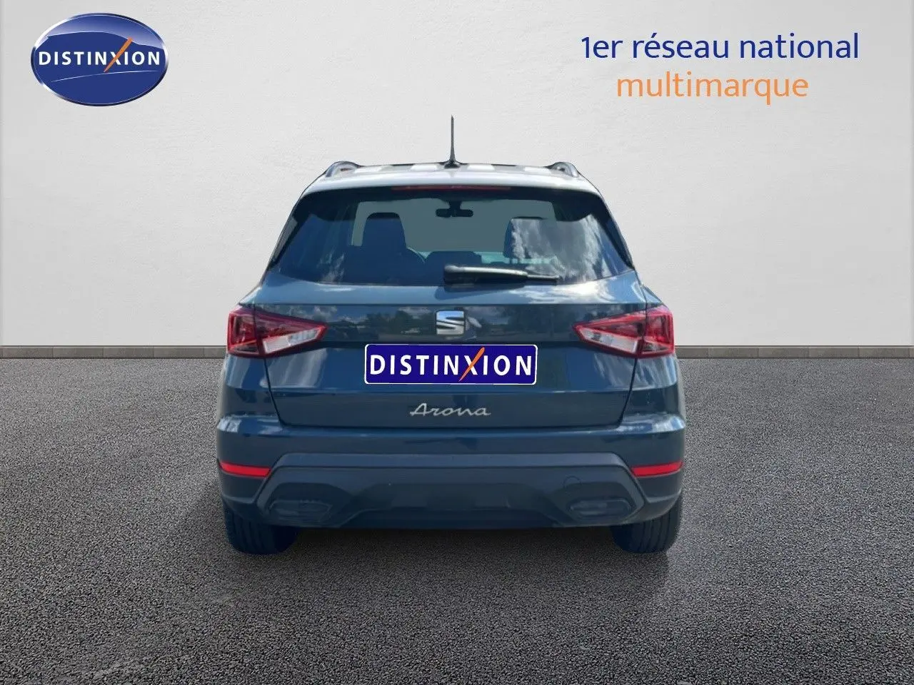 Vue arrière du SEAT Arona bleu Fjord avec toit blanc, version Style Special Edition 2025, sur sol gris.
