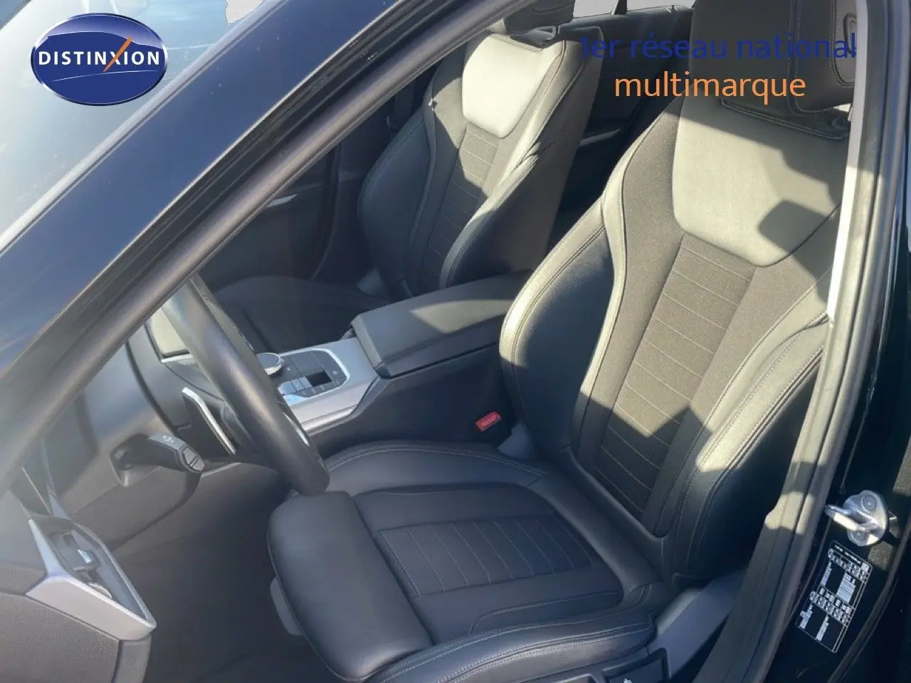 Vue intérieure côté conducteur de la BMW Série 3 Touring F31 noire, sièges en cuir noir et console centrale moderne.