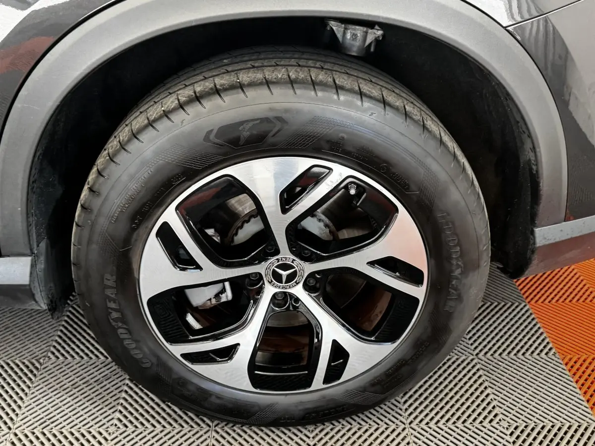 Gros plan sur la roue avant droite d’un Mercedes GLC 300 E Business Line gris foncé avec jante alliage bicolore.