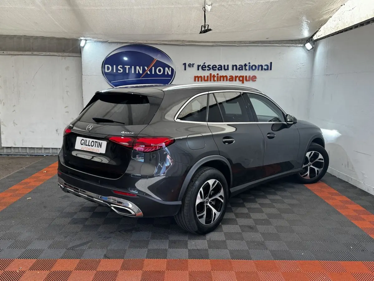 Mercedes GLC 300 E Business Line gris foncé, vue 3/4 arrière droit en intérieur avec jantes distinctives 4MATIC.