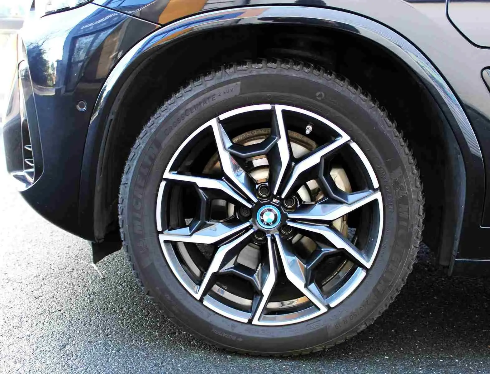Gros plan sur la roue avant droite du BMW X3 xDrive bleu métal 2023, mettant en valeur la jante alliage au design sportif.