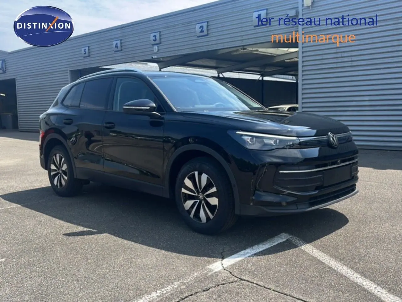 Volkswagen Tiguan 1.5 TSI noir grenadilla métal, vue 3/4 avant droite, finition moderne et jantes stylisées.