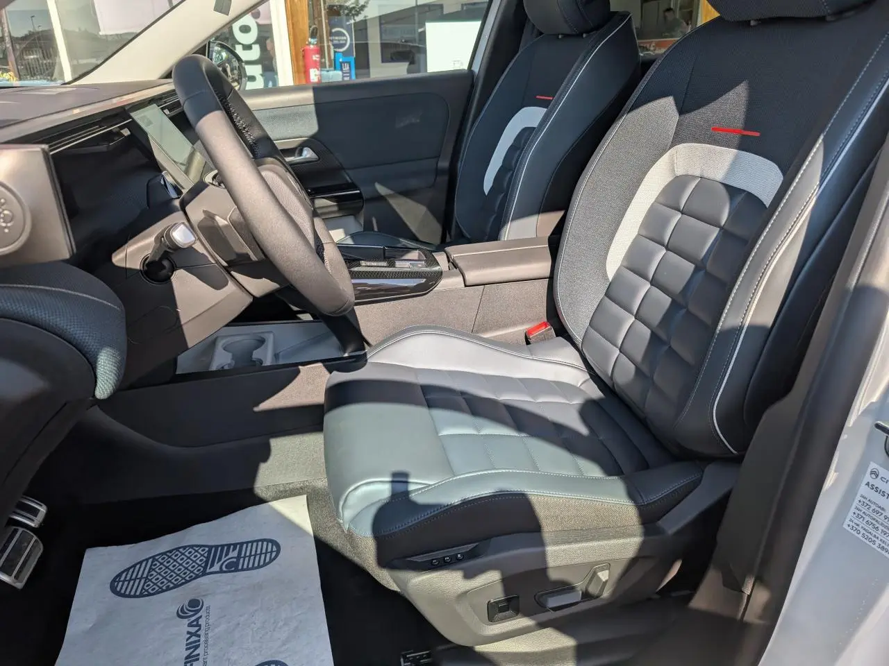 Vue intérieure côté conducteur du Citroën C5 Aircross 2026 avec siège avant bicolore gris et noir, volant multifonctions.