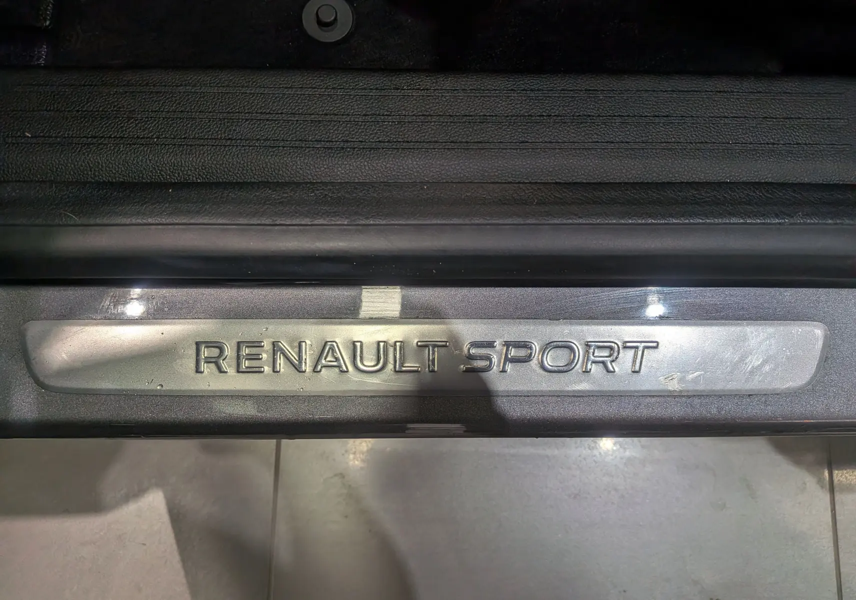 Gros plan sur la plaque de seuil de porte "RENAULT SPORT" du Renault Captur TCe 160 CH EDC R.S. LINE 2022.